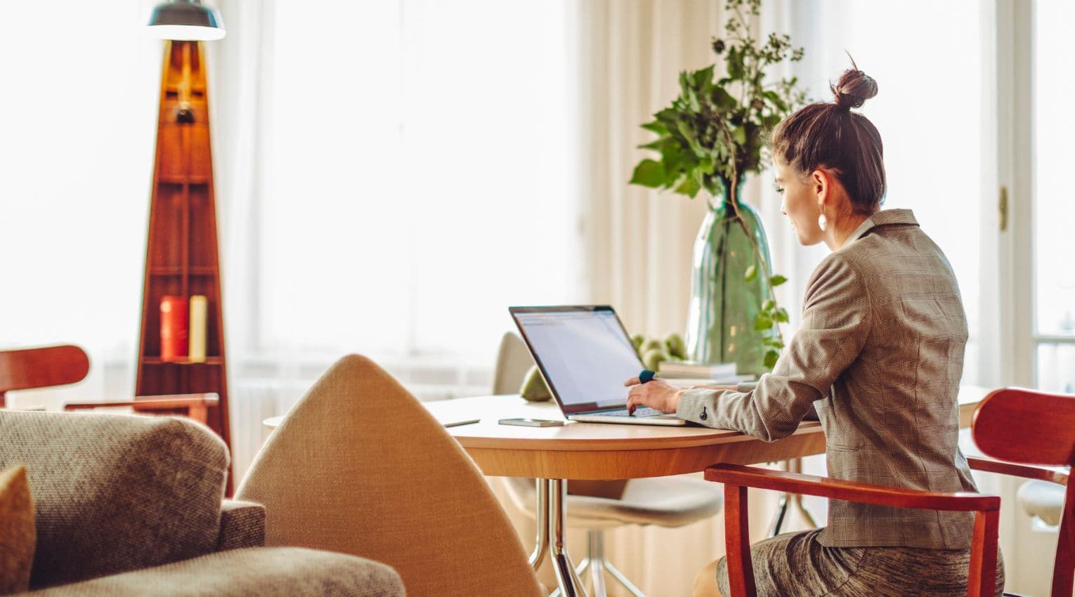 woman sitting in office at laptop